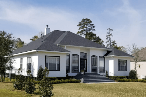 Shingled roofs are very popular, as shown on this White house, installed by Pride Roofing LLC