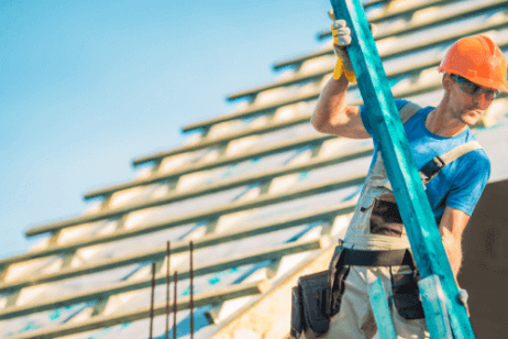 Pride Roofing LLC construction worker laying down roof on a commercial building