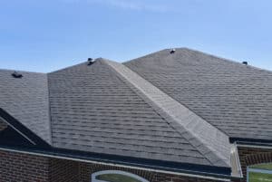 What is the best brand of roof shingles with Pride Roofing in Hammond, LA. Close up image of new shingles on roof of red brick house.